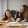 teacher helping girl learning english